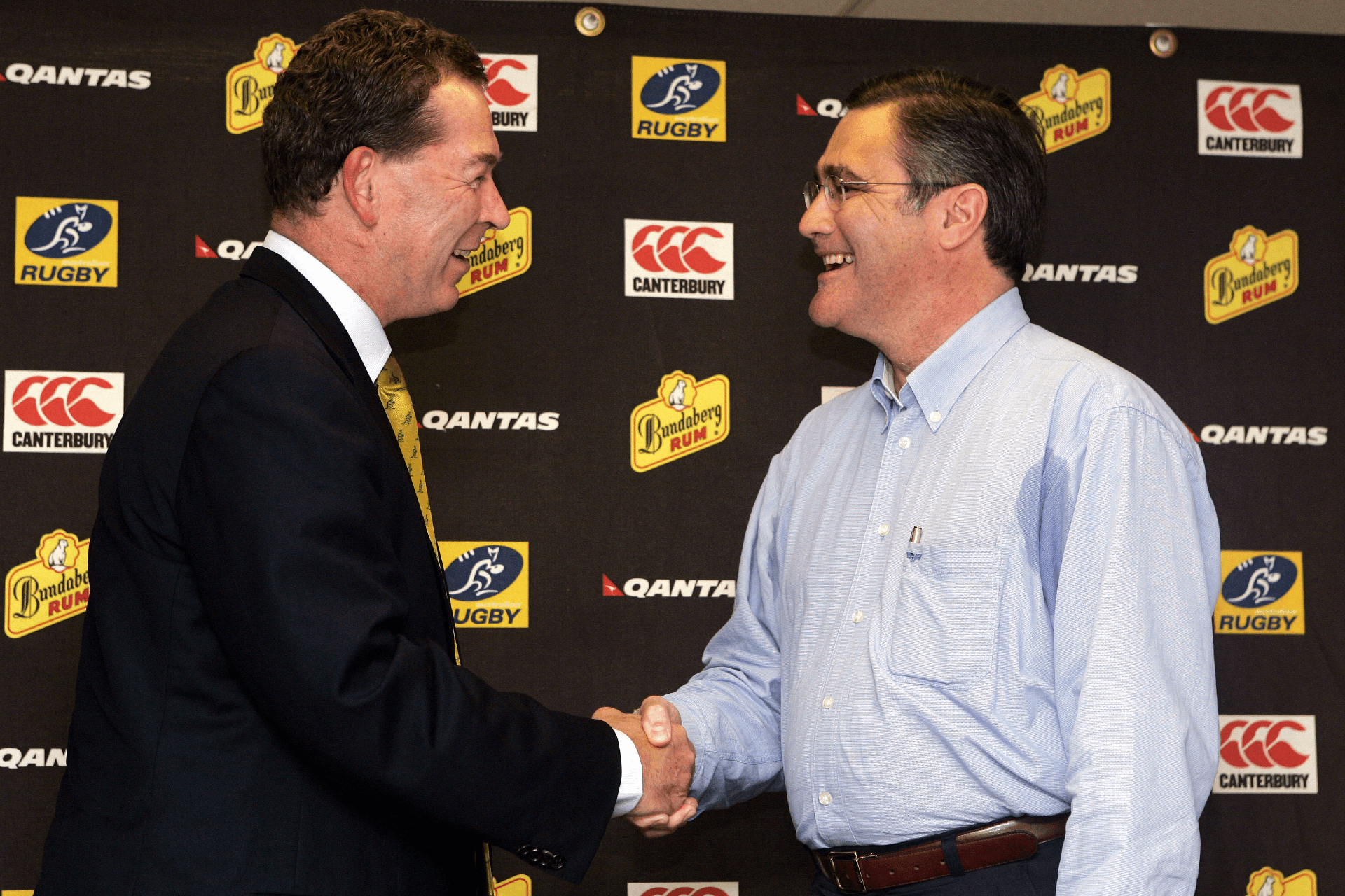  ARU Managing Director Gary Flowers (L) congratulates Western Australian Premier Dr Geoff Gallop during a press conference for the announcement of Perth as the location for a fourth Australian Super Rugby team