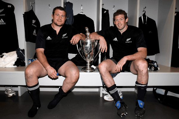 All Blacks pair Tony Woodcock (L) and Tom Donnelly celebrate with the Tri Nations trophy after their victory in 2010 over the Springboks