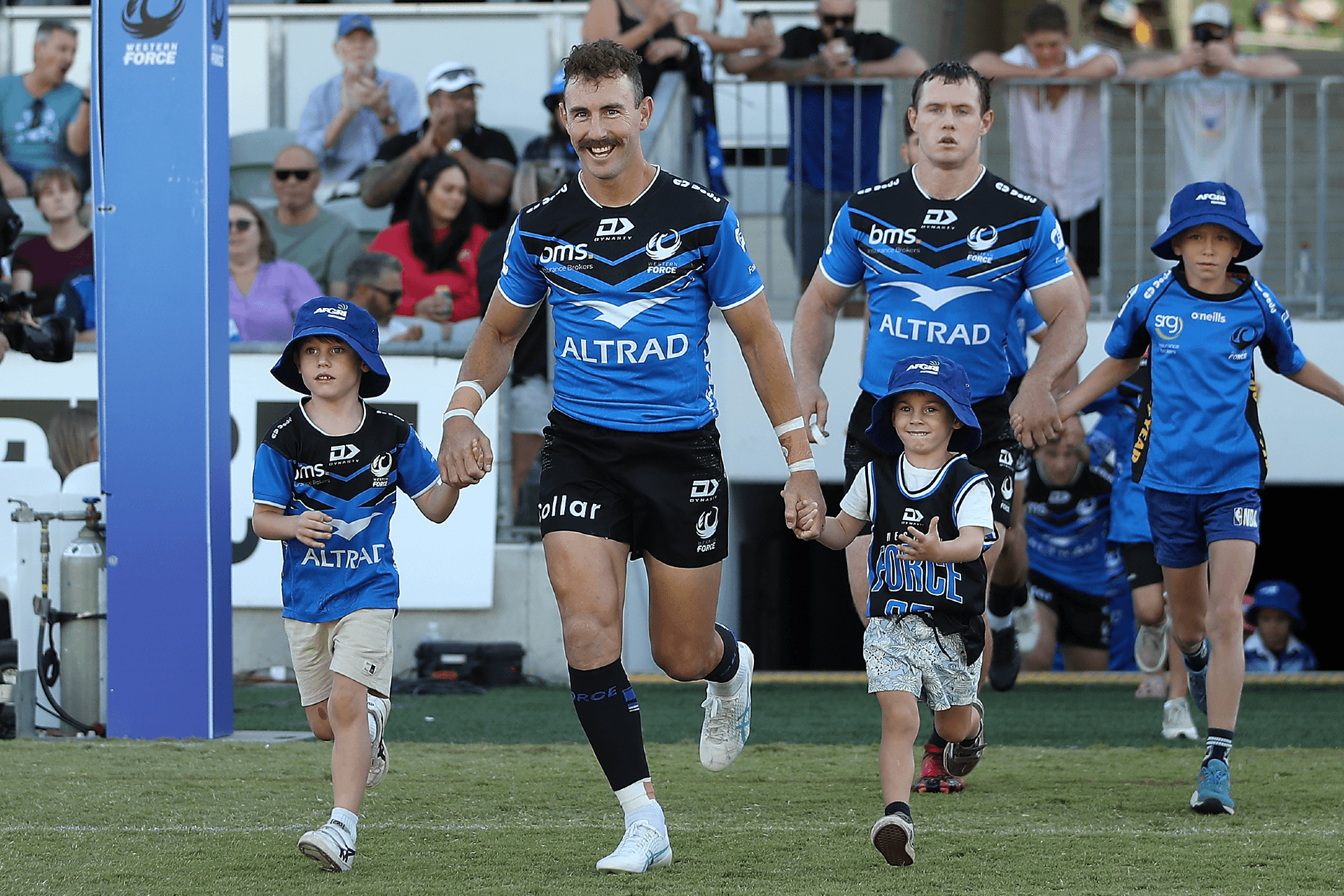 Nic White runs on to HBF Park with his sons Leo and Sonny