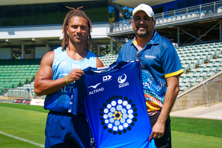Issak Fines-Leleiwasa and Kevin Bynder with the new First Nations warm-up tee